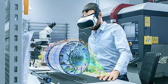 Factory engineer wearing VR headset designs engine turbine on holographic projection table 